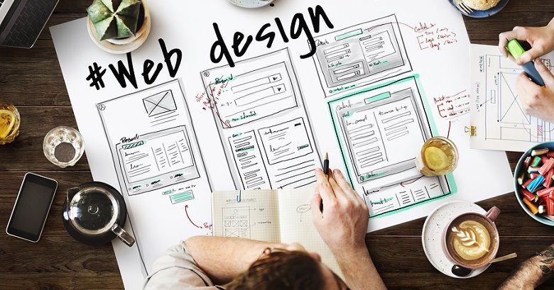 website designers discussing web design layout together 